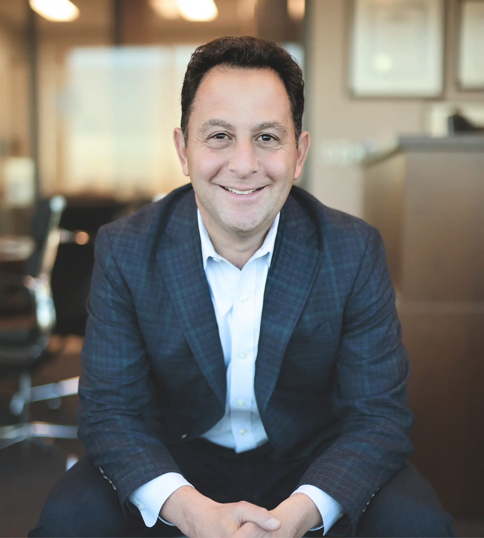 Peter Mallouk in business casual attire smiling at the camera.