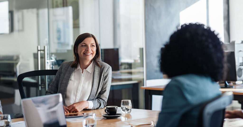 Advisor meeting with a client to discuss tax‑loss harvesting strategies, illustrating how selling losing investments to offset gains can improve a portfolio’s after‑tax returns