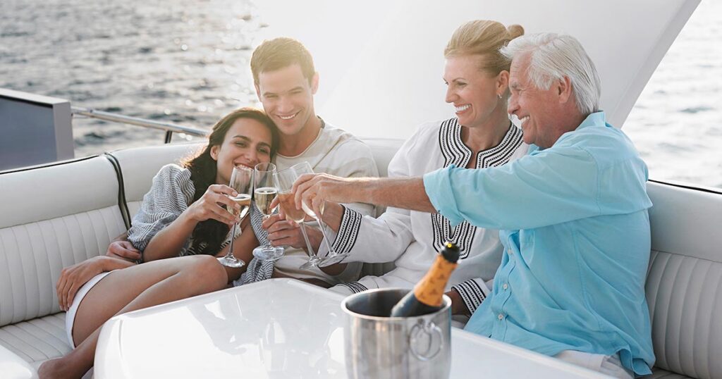 Multigenerational family celebrating together on a yacht, symbolizing the lifestyle and legacy supported by coordinated family office wealth management services