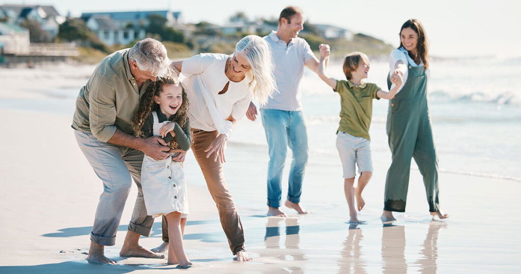 Multi-generational family enjoying time together at the beach, symbolizing long-term family office investment strategies and legacy-focused wealth management