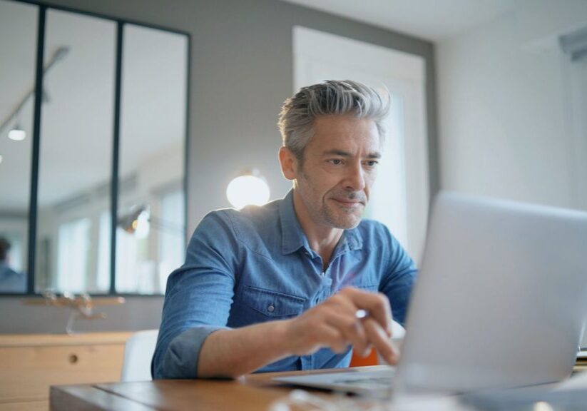 Man at laptop typing