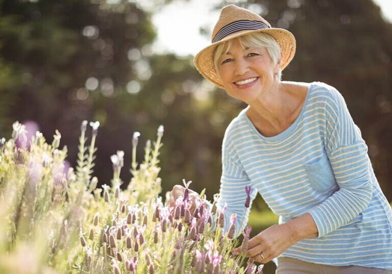 Happy senior woman ponders how to create a retirement paycheck