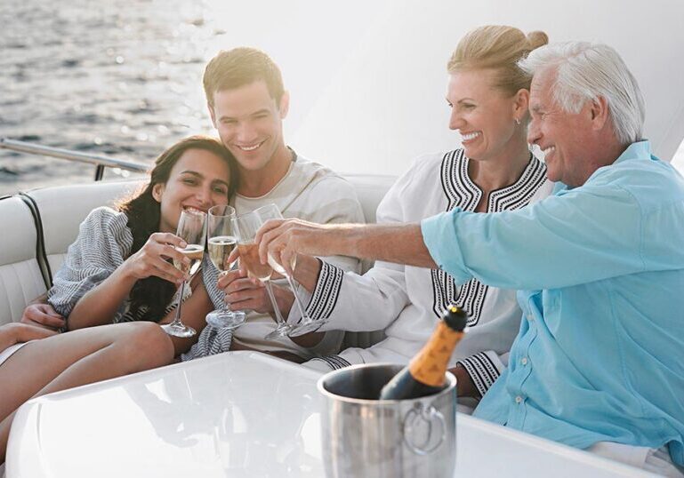 Multigenerational family celebrating together on a yacht, symbolizing the lifestyle and legacy supported by coordinated family office wealth management services