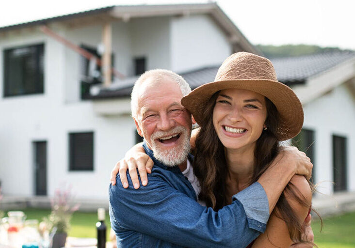 Senior father hugs daughter who will inherit the family home
