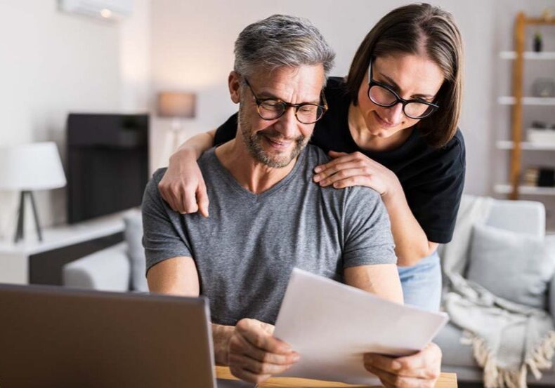 Couple Doing Taxes And Family Budget On Computer