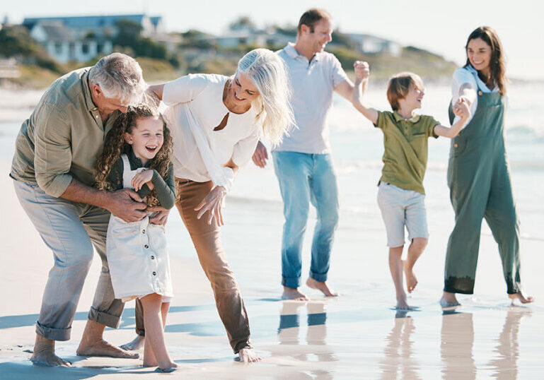 Multi-generational family enjoying time together at the beach, symbolizing long-term family office investment strategies and legacy-focused wealth management