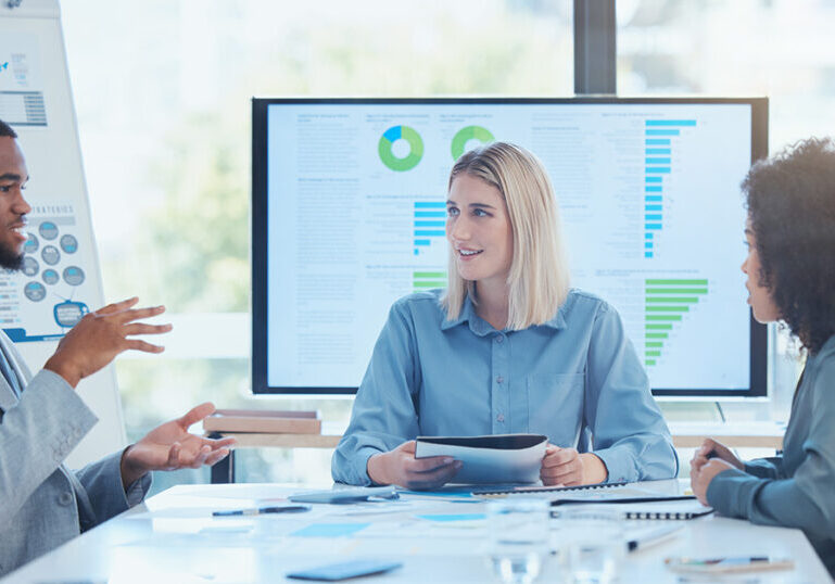 Business team going over data findings in a meeting to inform future strategies