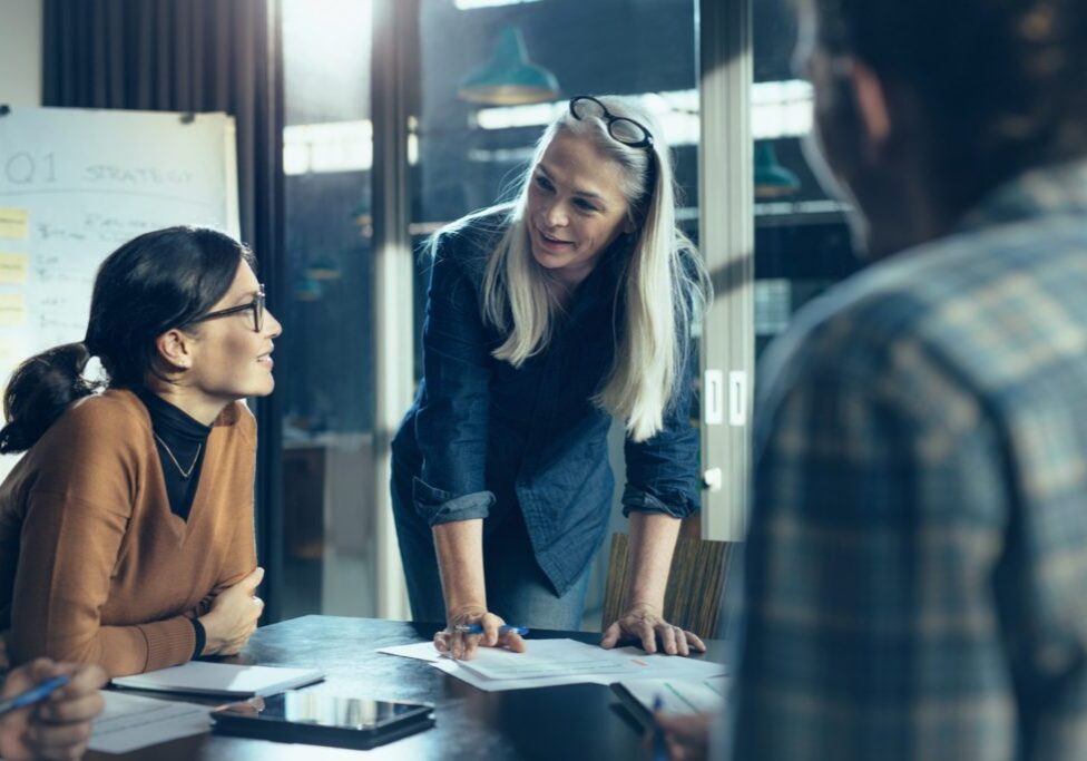 Group of coworkers discussing work in casual setting