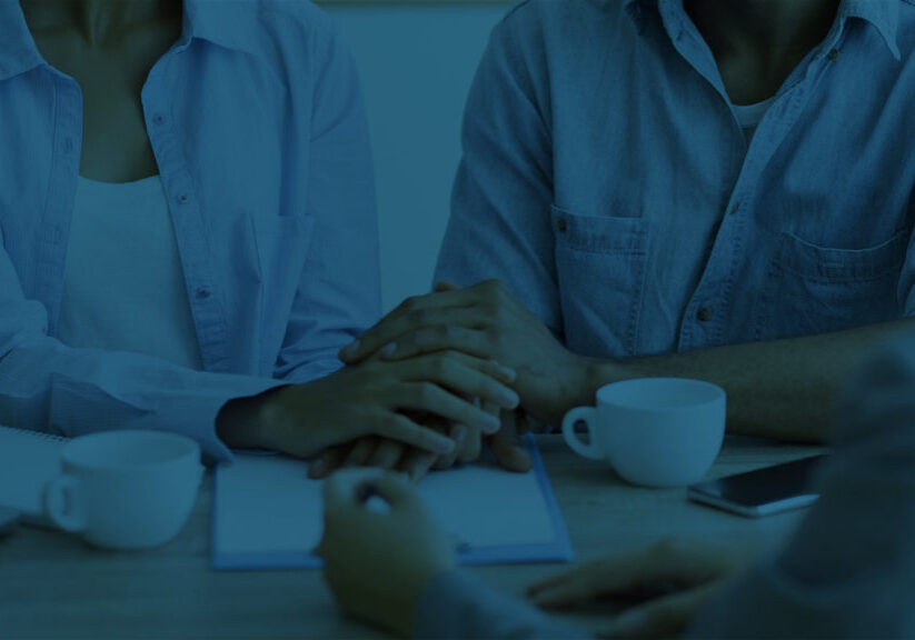 Couple reviewing documents with financial planner