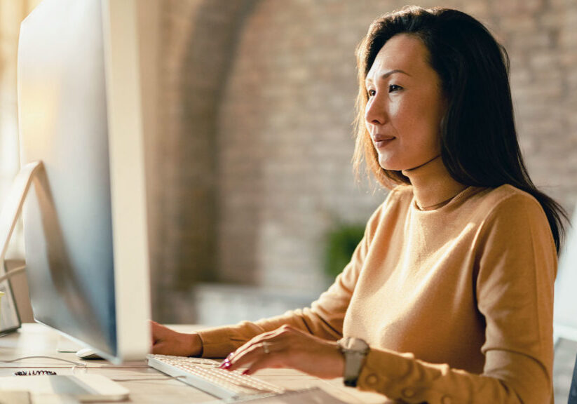 A woman is working on her laptop