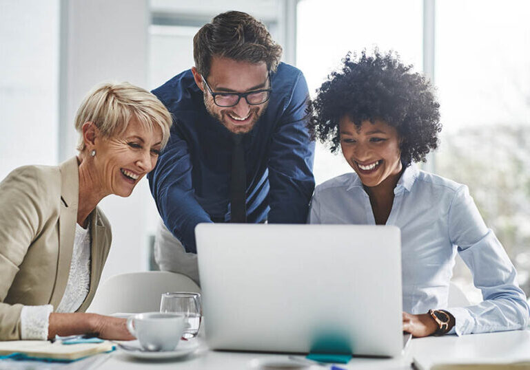 Laptop, collaboration and business people in the office while working on a company project. Technology, teamwork and team doing corporate research in discussion together with technology in workplace.