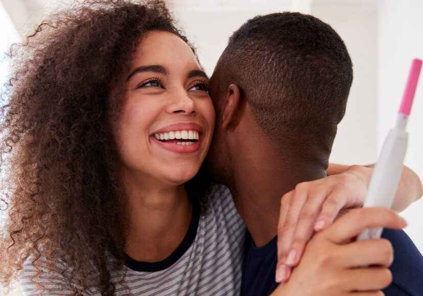 Couple Celebrating Positive Home Pregnancy Test Result